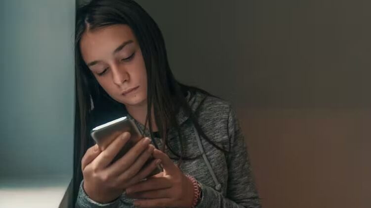 young girl on mobile phone - The Deeping