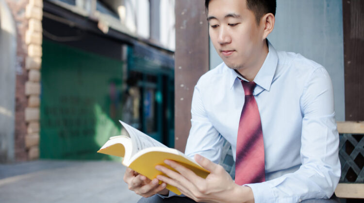 Asian man reading a book - The Deeping