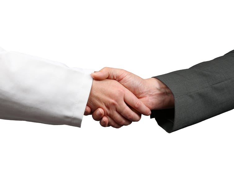 file-20250120-15-1xekfa - The Deeping labcoat arm shakes arm in dark suit