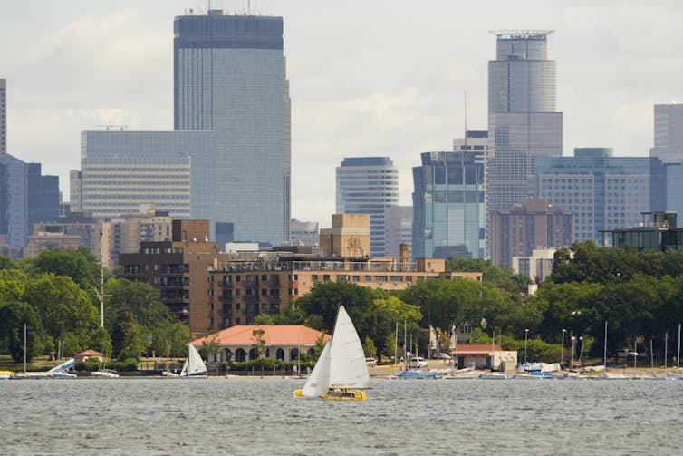 file-20250124-17-6azvss - The Deeping A lake with sailboats and a city skyline in the background